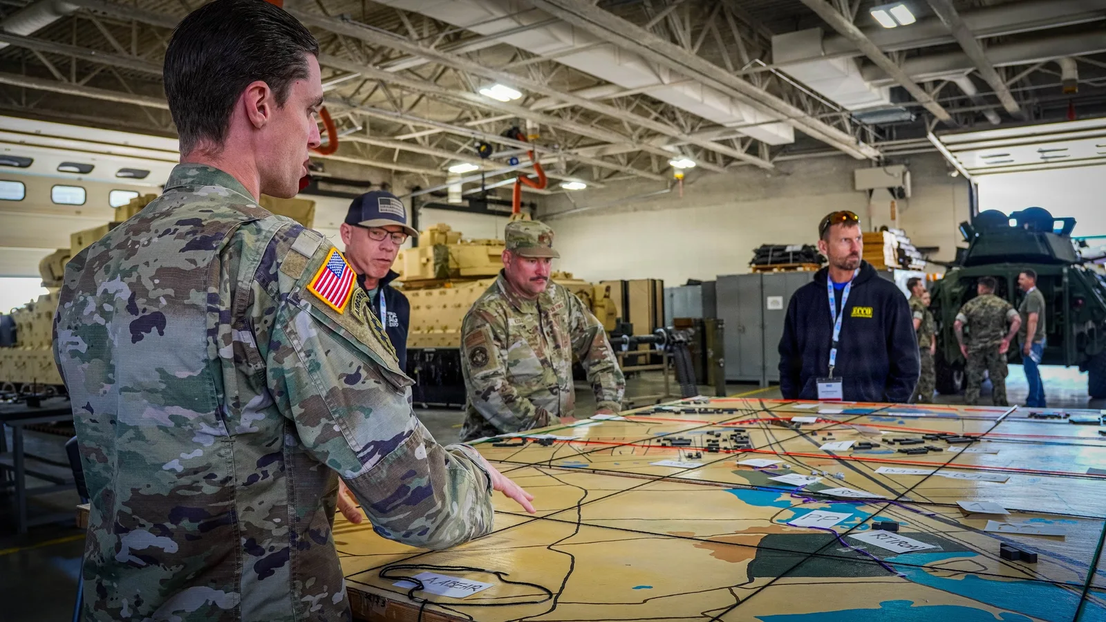 U.S. military service members reviewing an operational briefing.