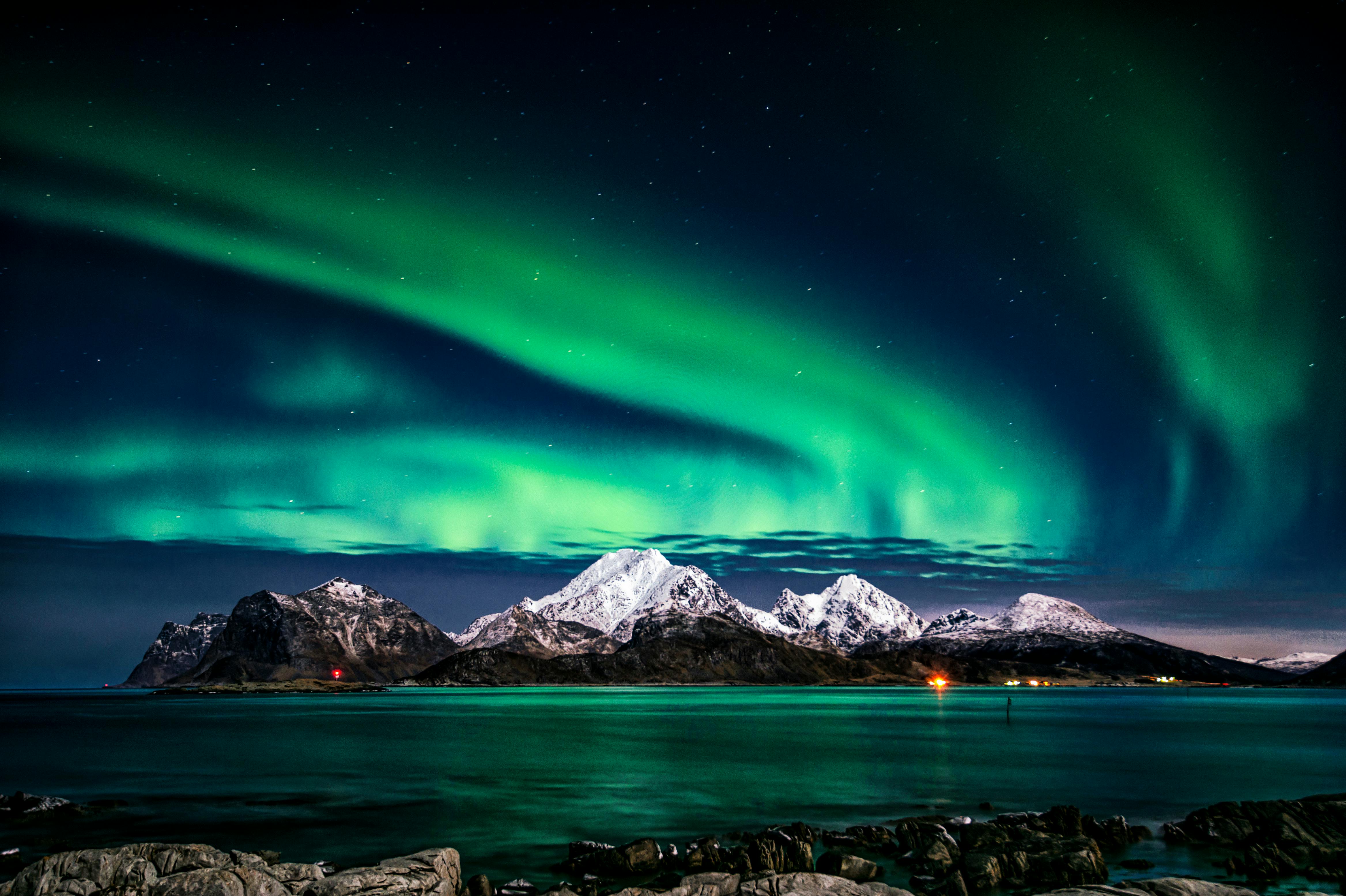 Northern lights aurora borealis dancing in green and purple across an Alaskan winter sky