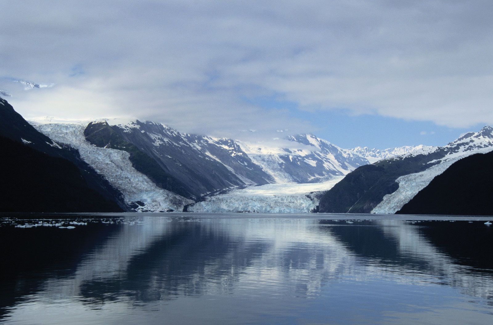 Prince William Sound and the Chugach Mountains reflected in calm waters near Valdez, Alaska