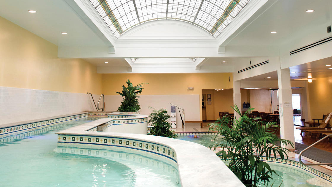 Hot Springs National Park in Arkansas, showing the historic Bathhouse Row along the promenade with the park's natural hot springs flowing nearby