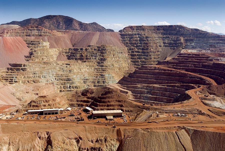 Open-pit copper mine in Morenci, Arizona, showing terraced mining operations and heavy machinery working the site