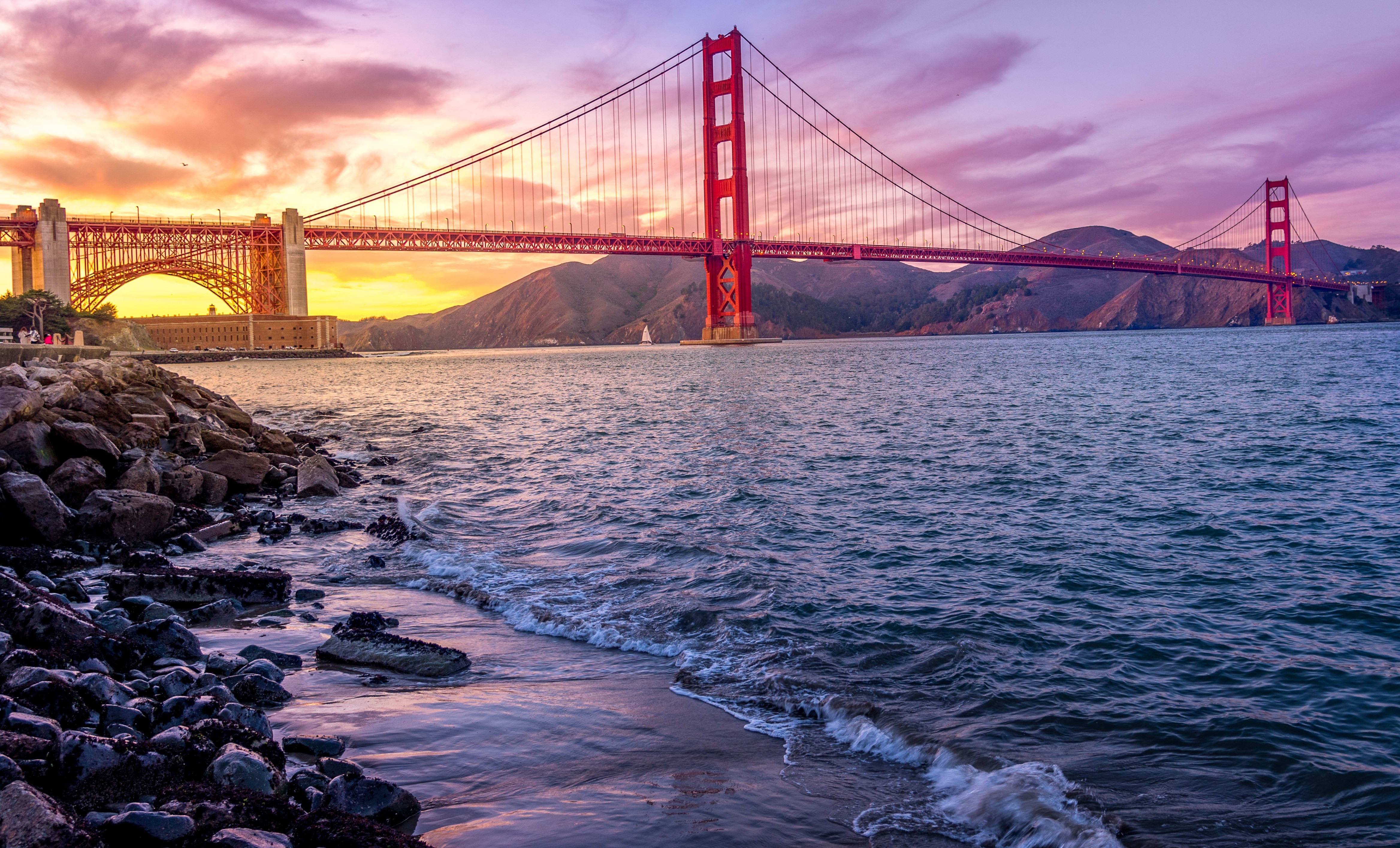 Golden Gate Bridge emerging from morning fog over San Francisco Bay, California