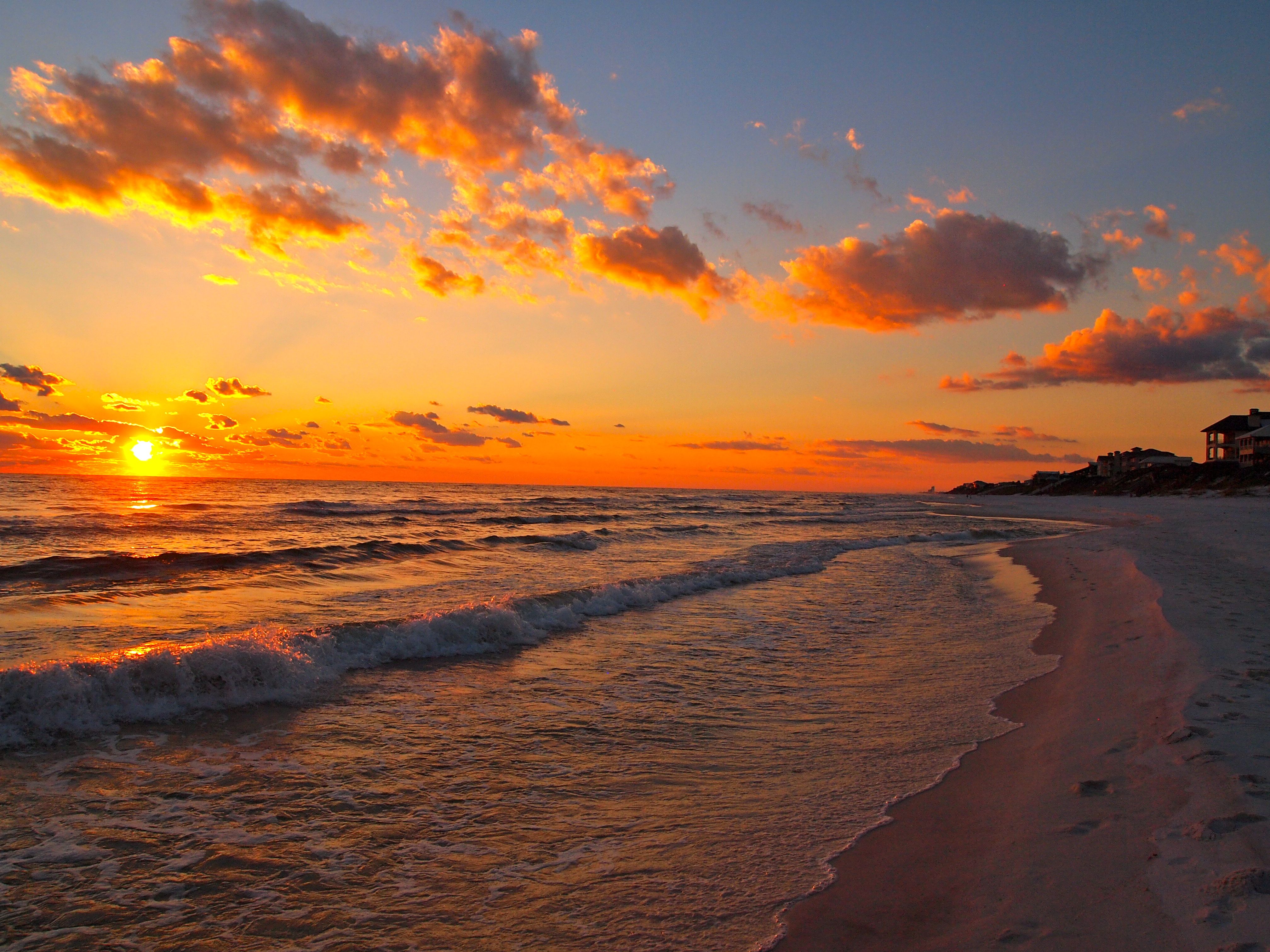 White sand beach and crystal-clear turquoise water along Florida's Gulf Coast at sunset