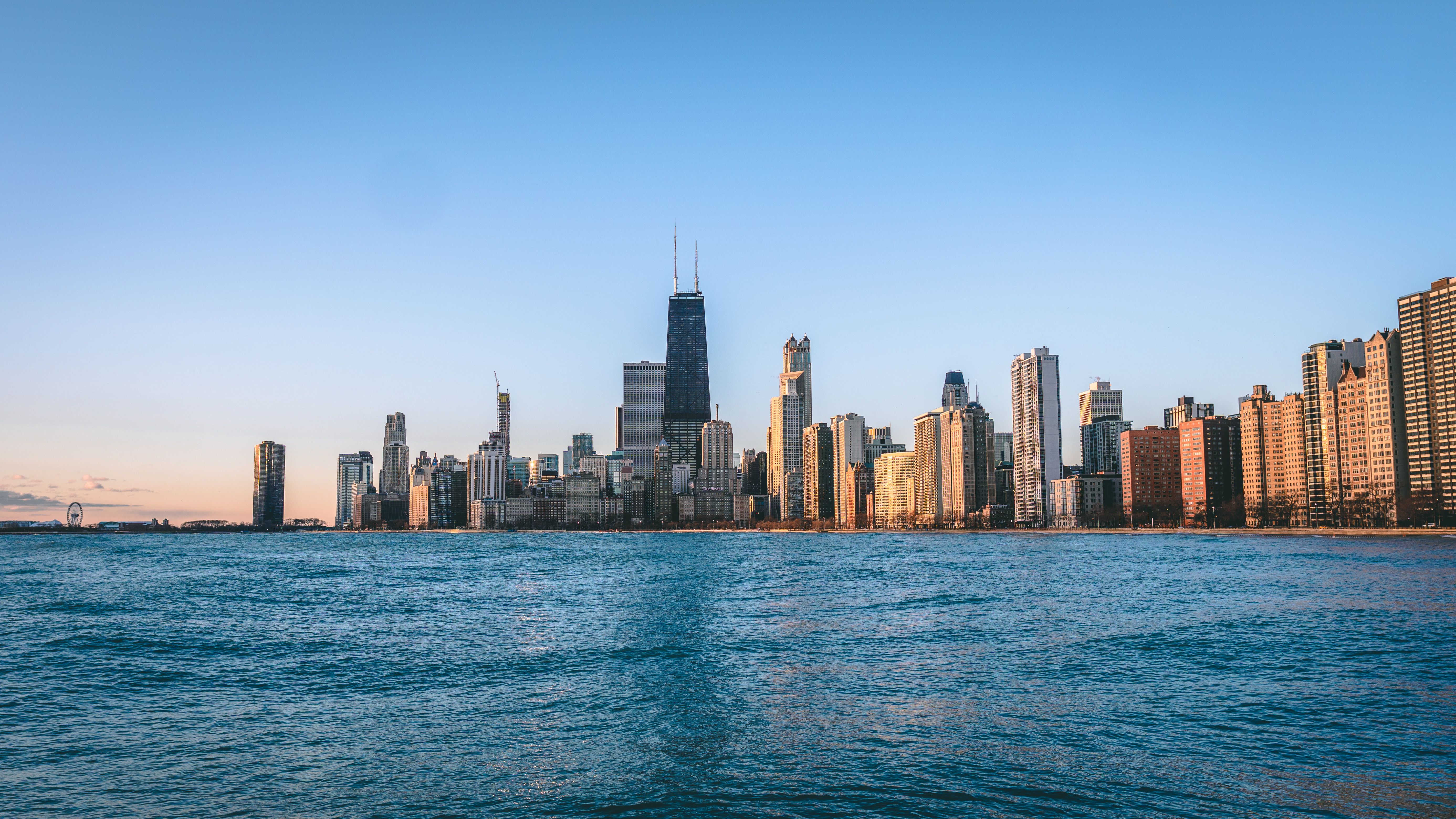 Chicago's iconic skyline reflecting in Lake Michigan at dusk