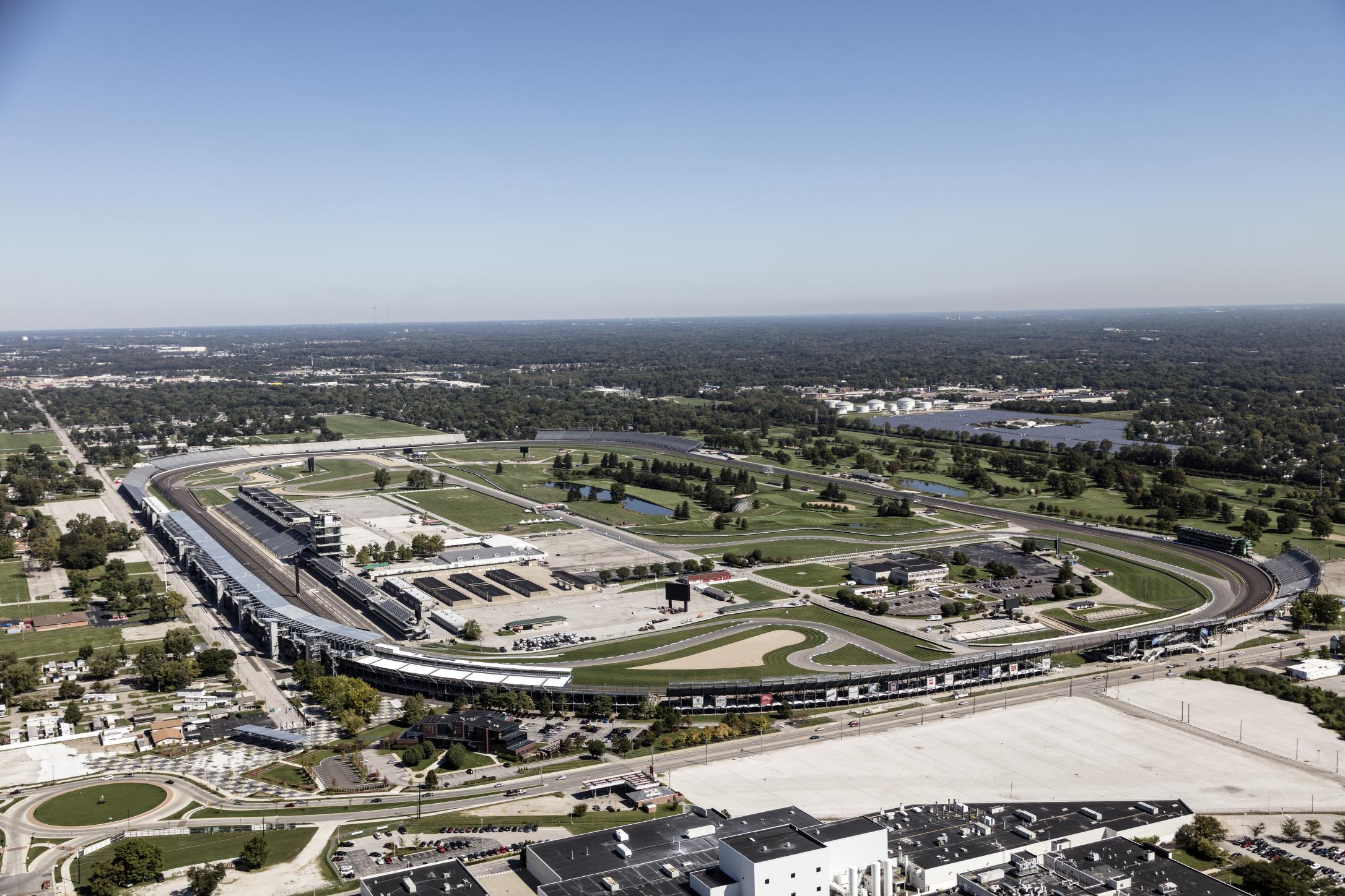 Aerial view of the Indianapolis Motor Speedway oval track with grandstands packed with racing fans on race day